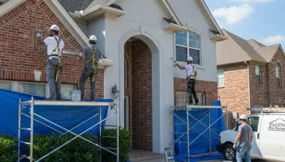 Professional Fort Worth, TX painters painting a home exterior for a local painting service